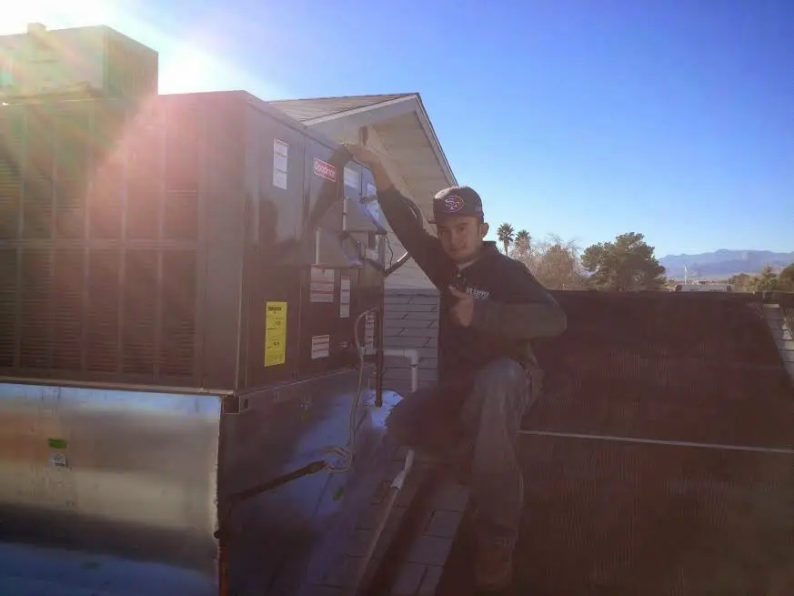 HVAC technician performing HVAC Inspection on a rooftop unit in New Lenox